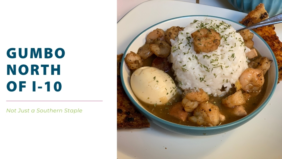 Bowl of gumbo with rice and shrimp on top and served with boiled egg